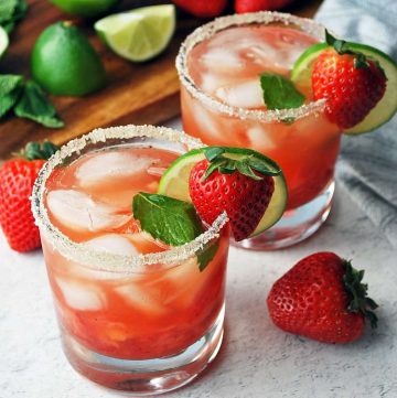 close up of two strawberry mojitos in low ball glasses