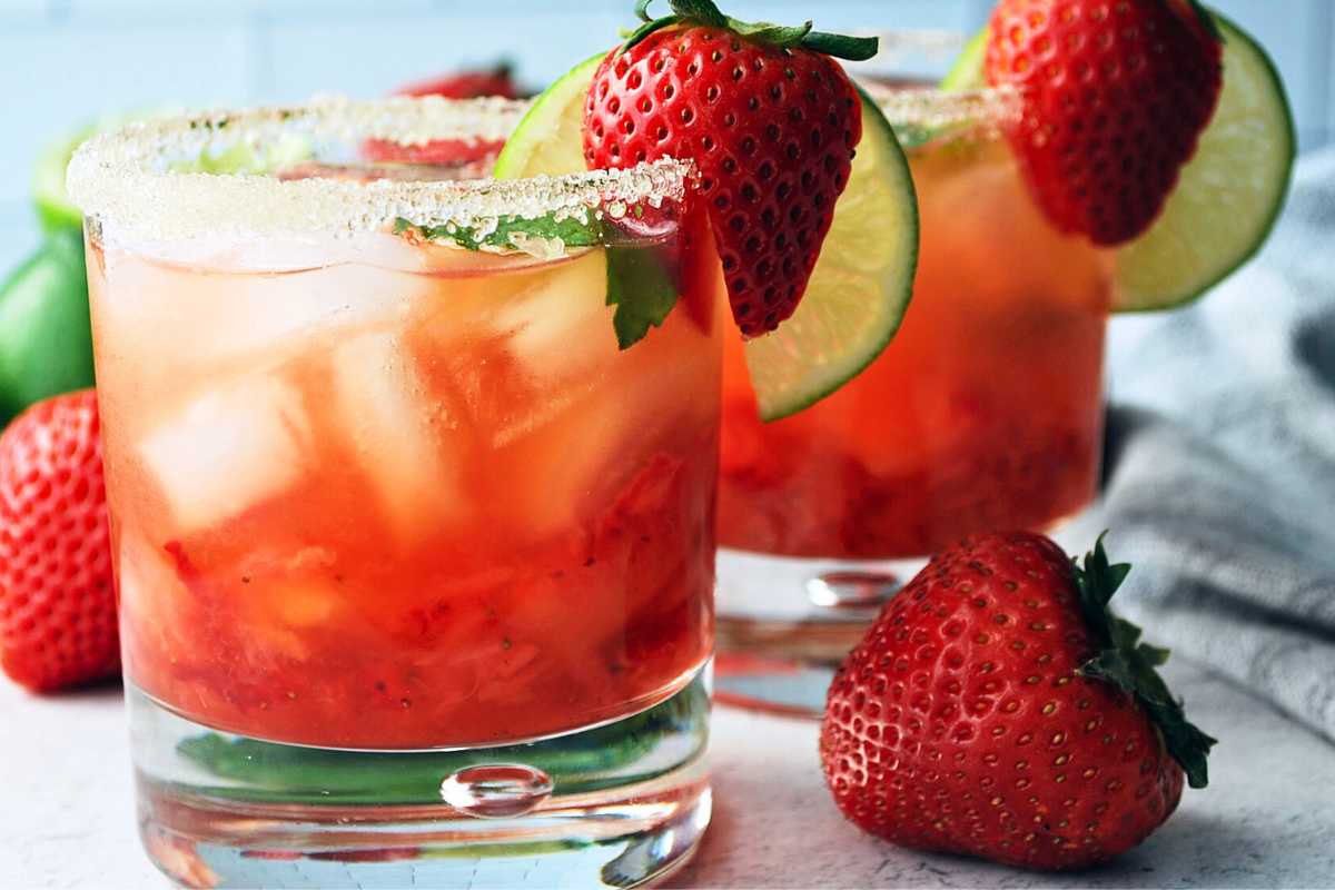 close up of two glasses of strawberry mojito made with fresh strawberries and lime
