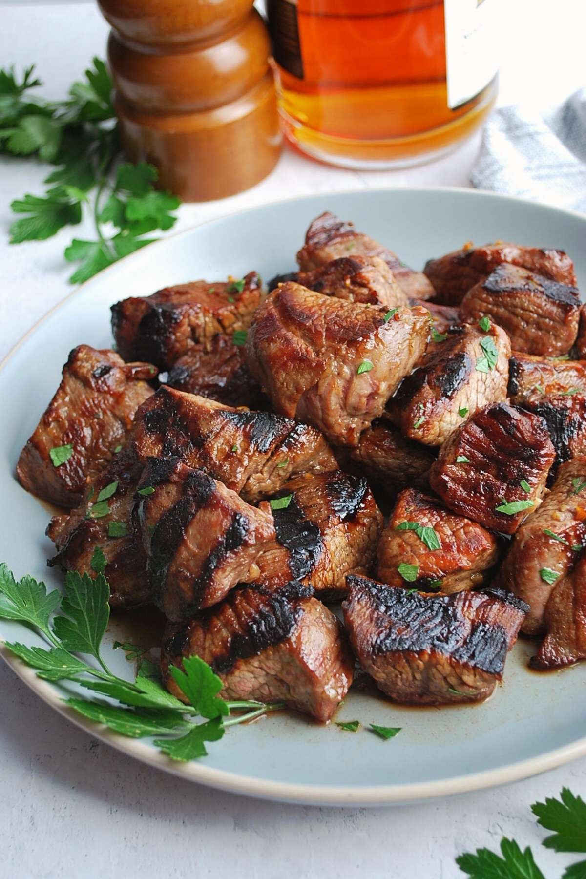 grilled beef tips on a plate with parsley