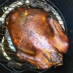 whole smoked turkey on a grill