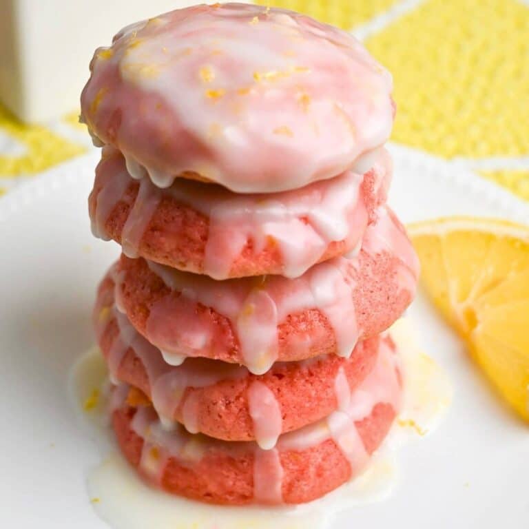 a stack of strawberry cookies dripping with lemon glaze