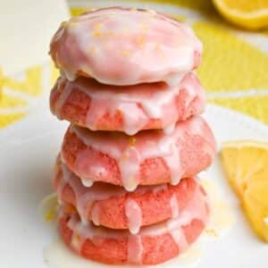 stack of strawberry cookies dripping with lemon icing