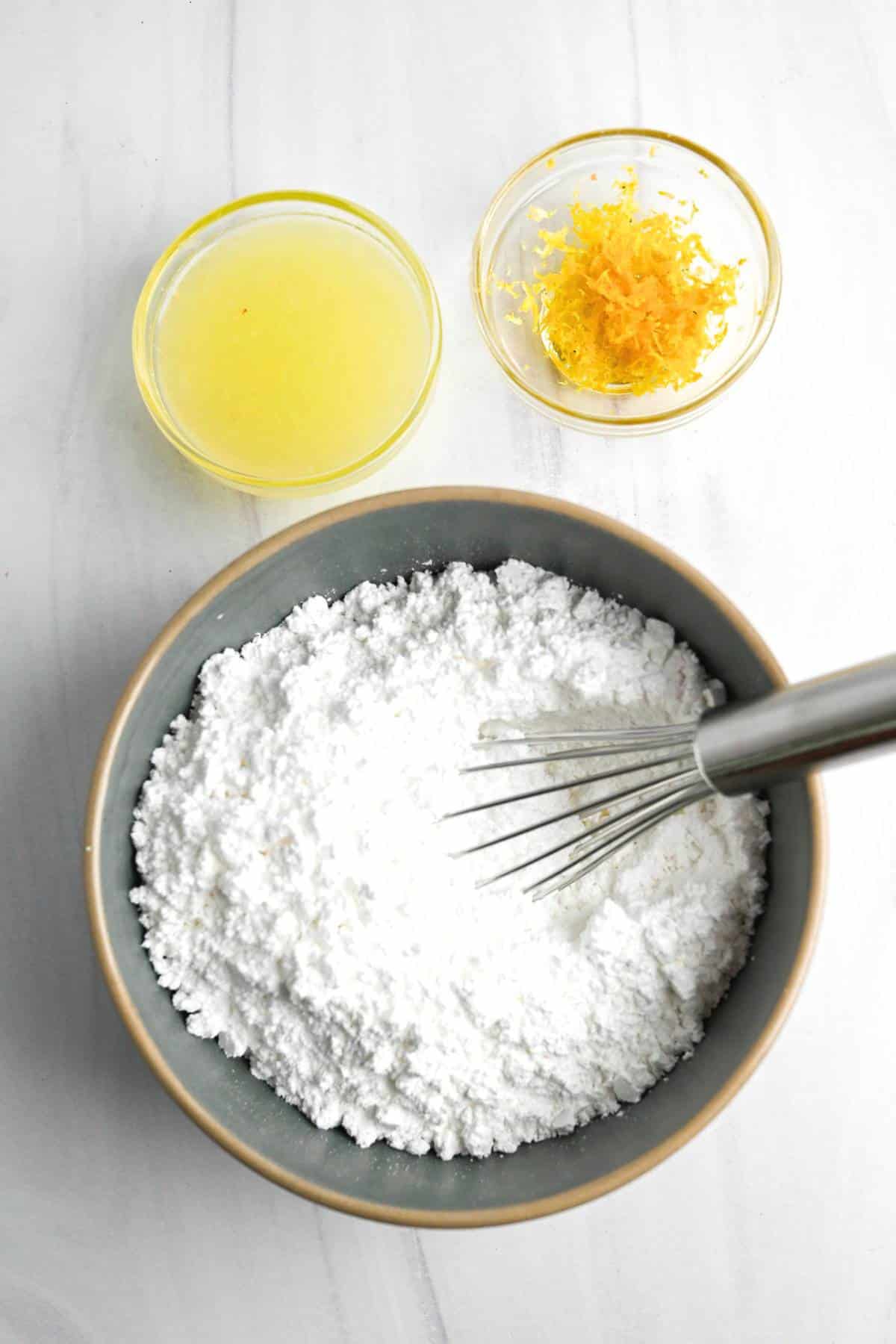 a bowl of powdered sugar, lemon juice, and lemon zest 