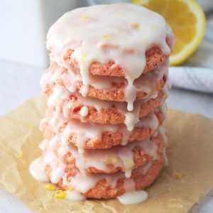 close up of a stack of strawberry cookie dripping with lemon glaze