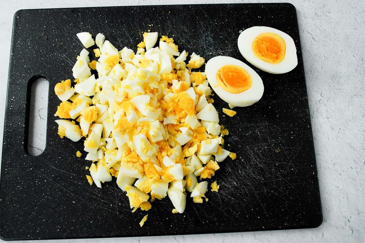 chopped eggs for egg salad on a cutting board