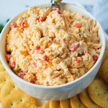 close up of jalapeno pimento cheese in a serving bowl with crackers