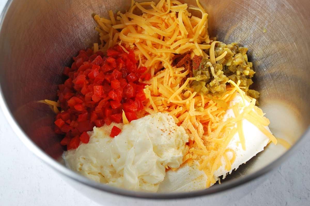 ingredients for pimento cheese in a mixing bowl
