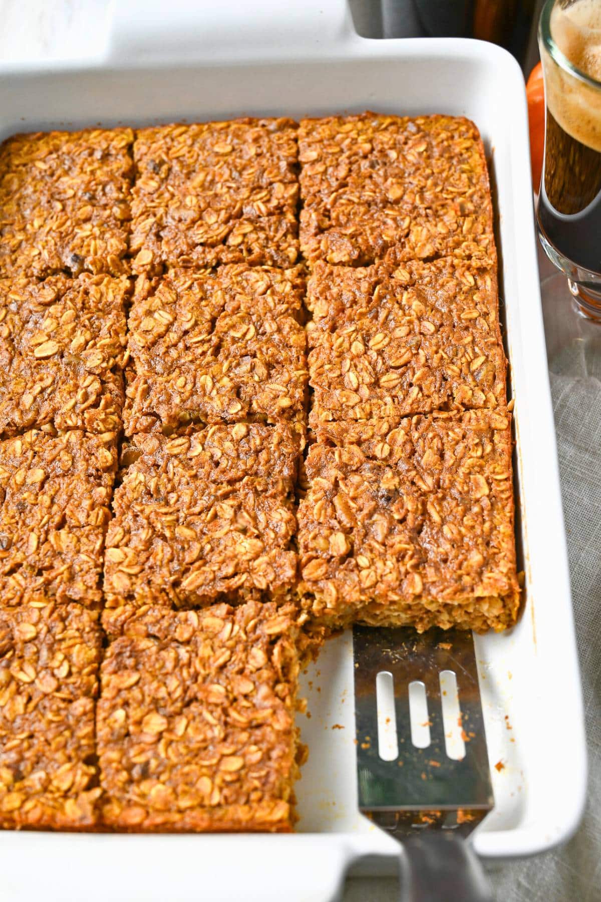 pumpkin baked oats sliced into squares in a baking dish