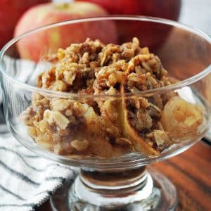 a bowl of sugar free apple crisp in a clear dessert dish