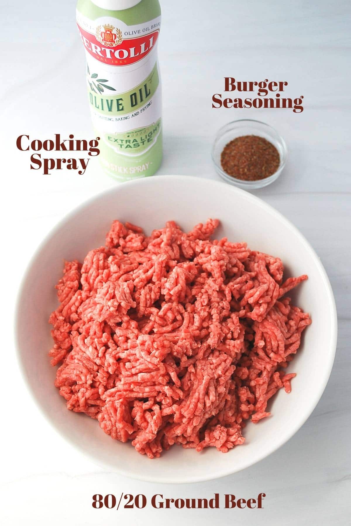 ground beef in a bowl with a dish of burger seasoning and cooking spray