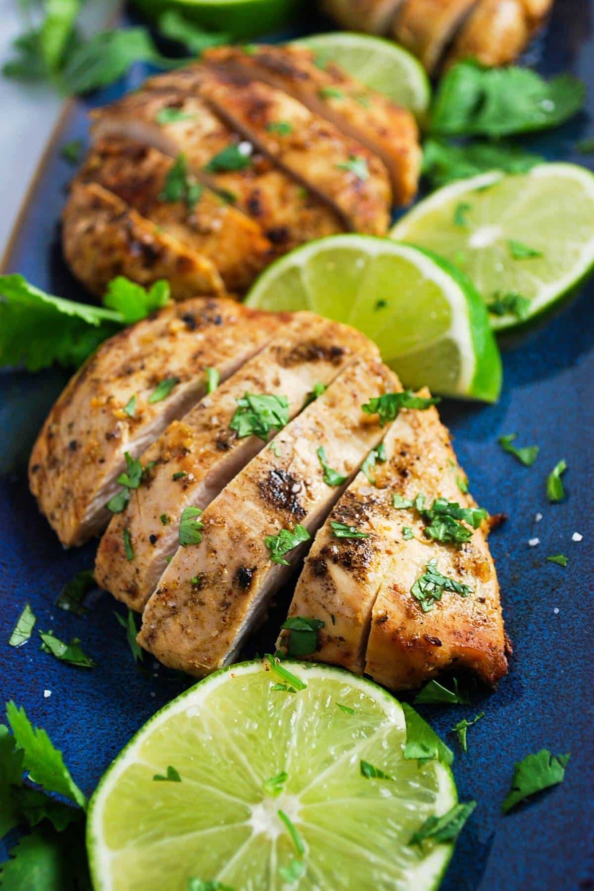 grilled chicken breasts marinated and cooked in Mexican chicken marinade topped with fresh cilantro and sliced limes