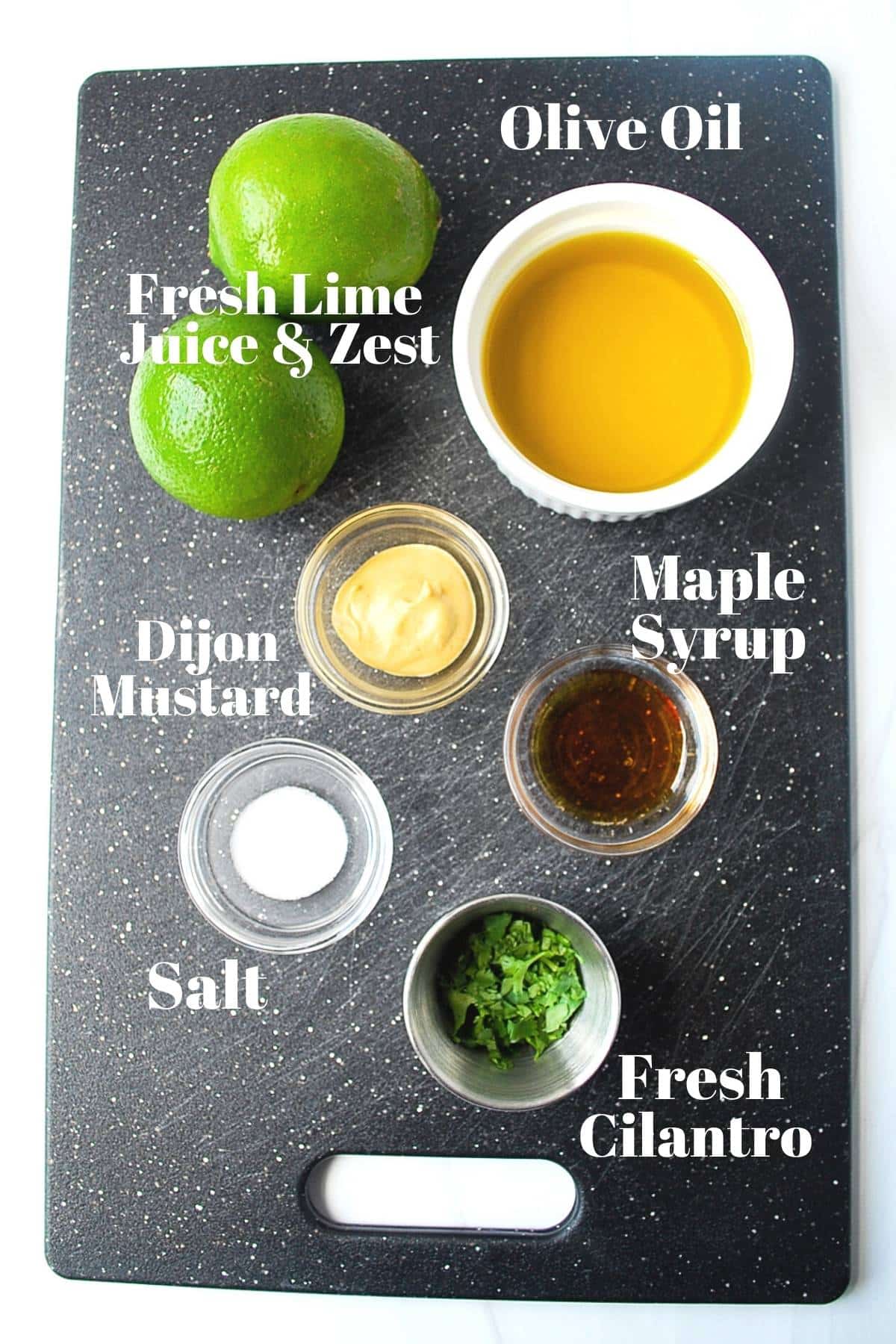 Cilantro lime dressing ingredients on a black cutting board
