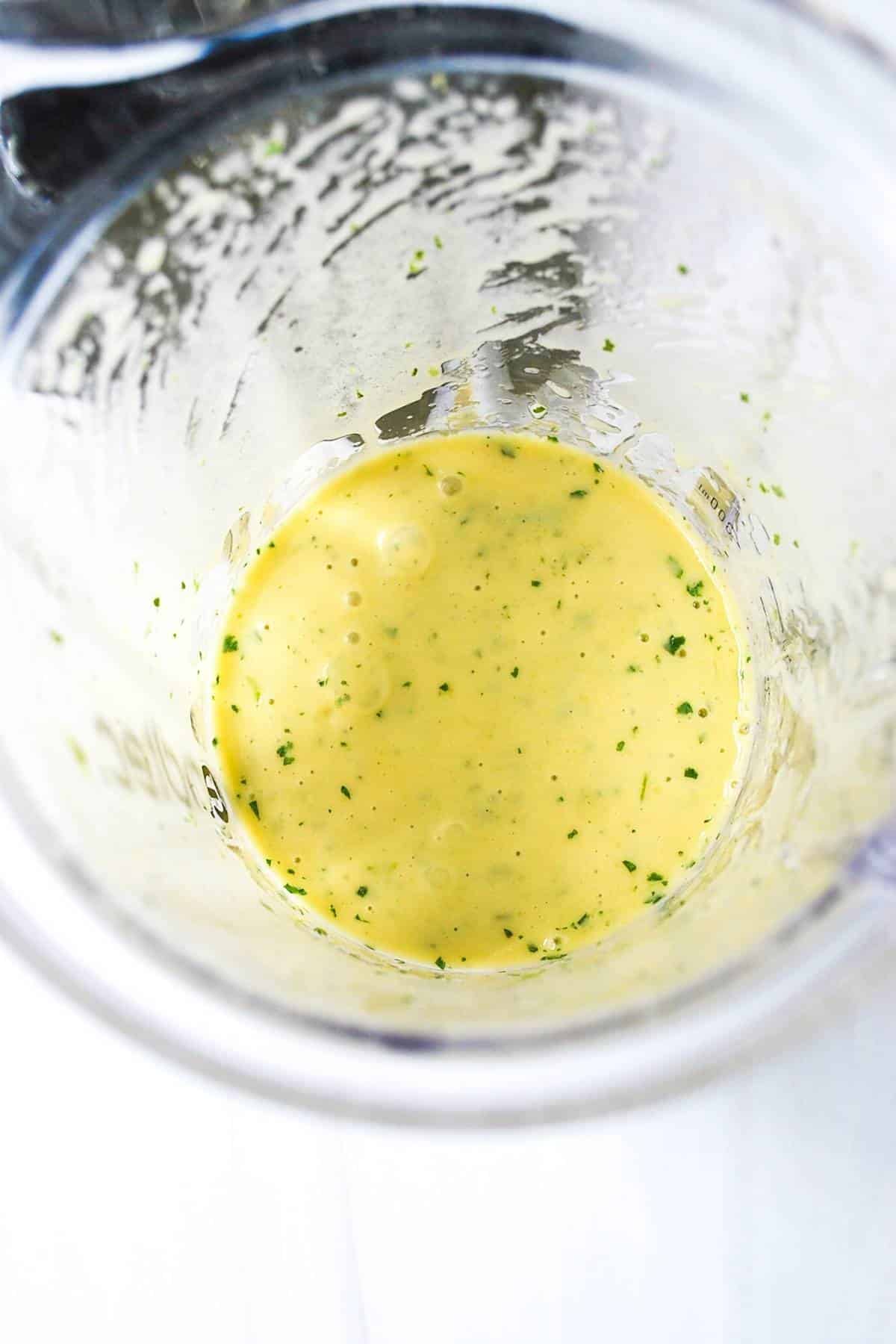 blended cilantro lime dressing in a blender jar