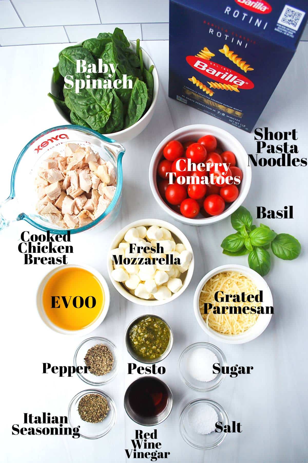 ingredients for chicken pesto pasta salad measured out on a counter