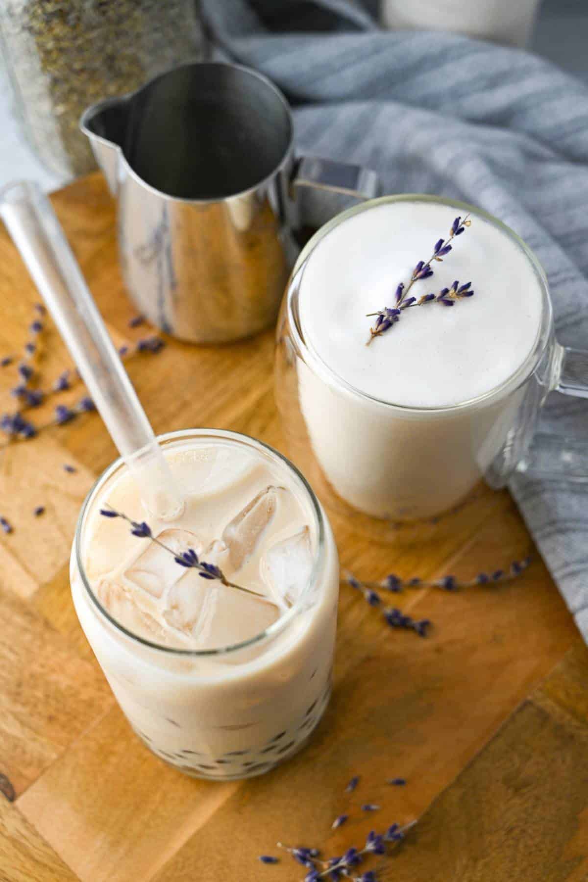 overhead photo of an iced and hot lavender milk tea with dried lavender stems on top