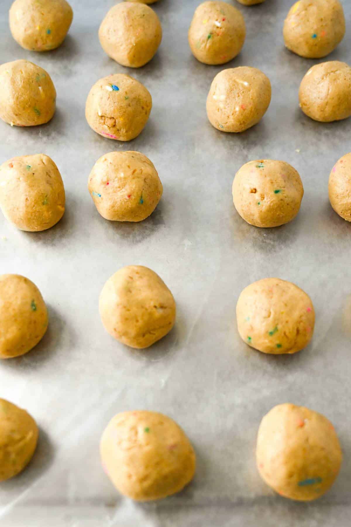 protein bombs rolled into balls on a lined baking sheet