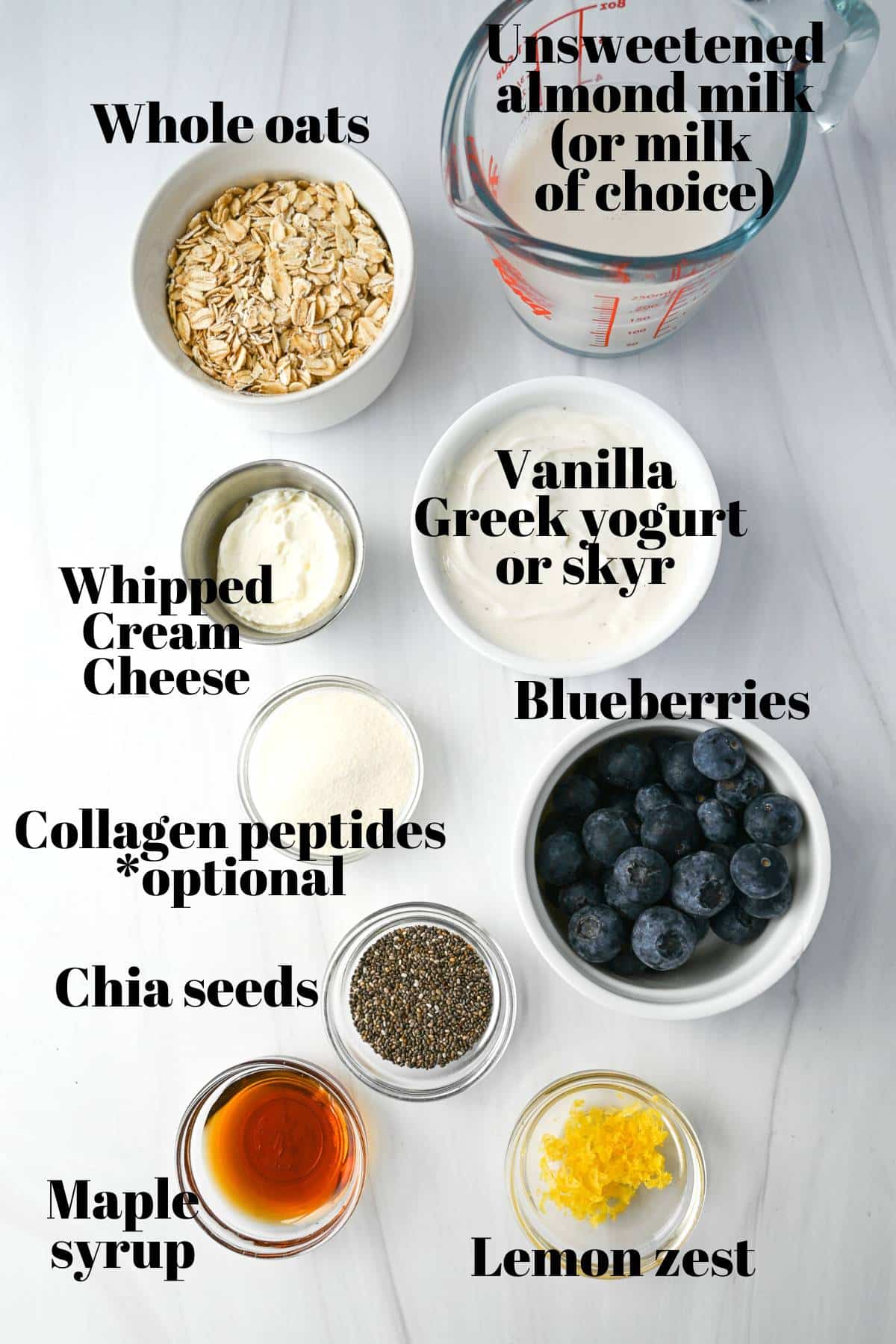 ingredients for blueberry cheesecake overnight oats measured out in containers on a counter