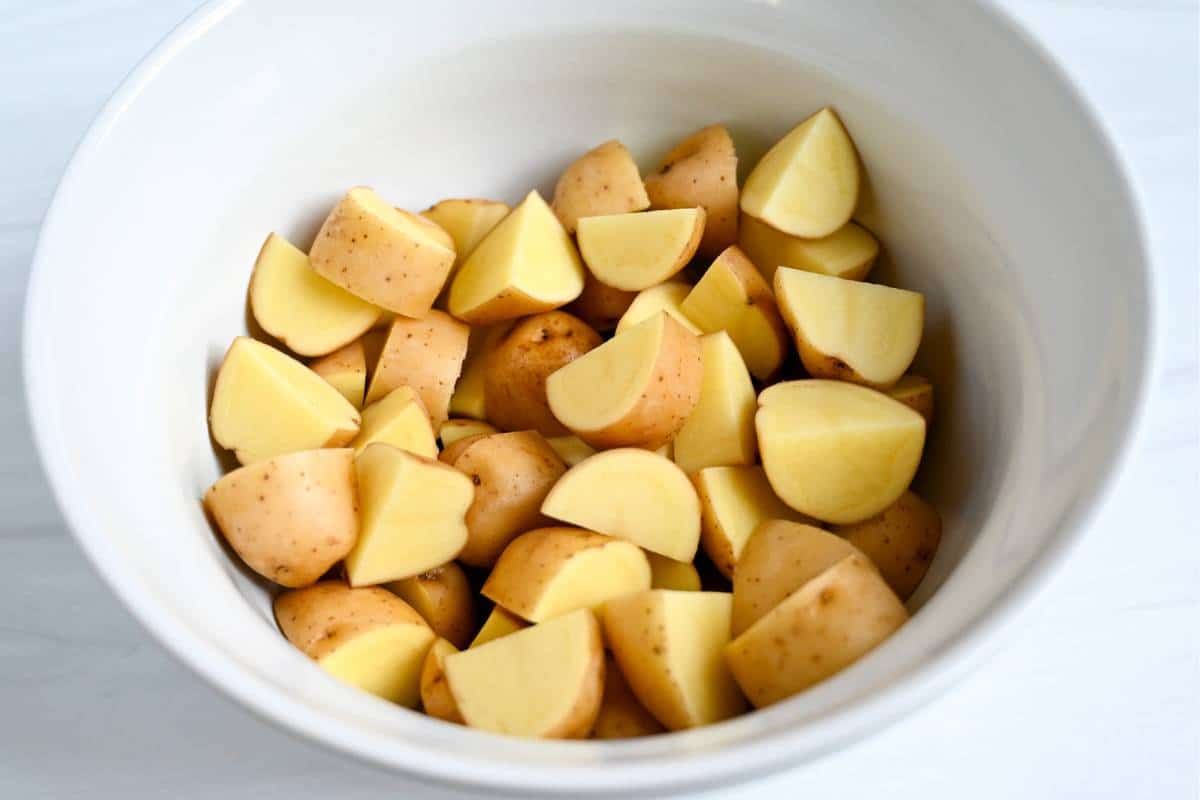 dutch potatoes sliced into quarters in a white bowl