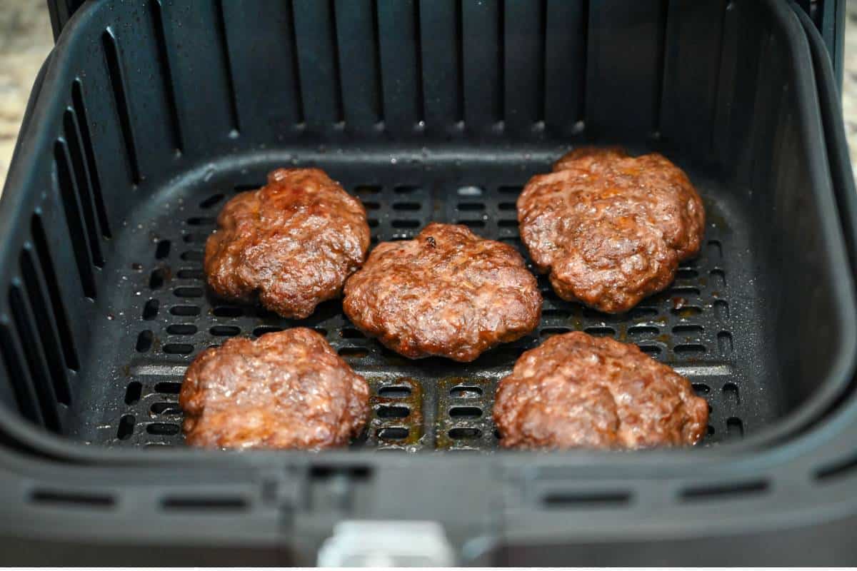 beef sausage cooked in an air fryer basket