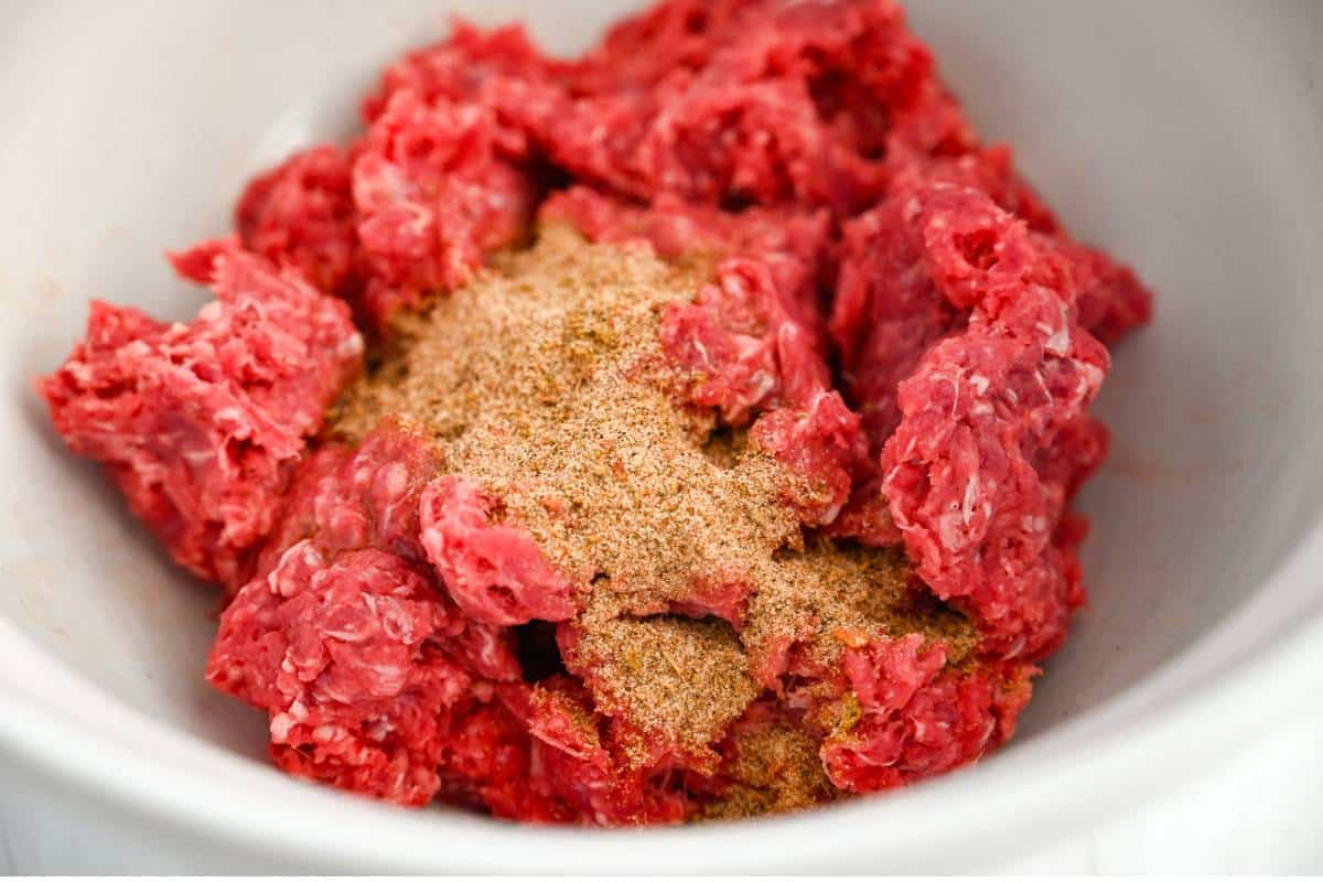 ground beef with sausage seasoning in a large bowl