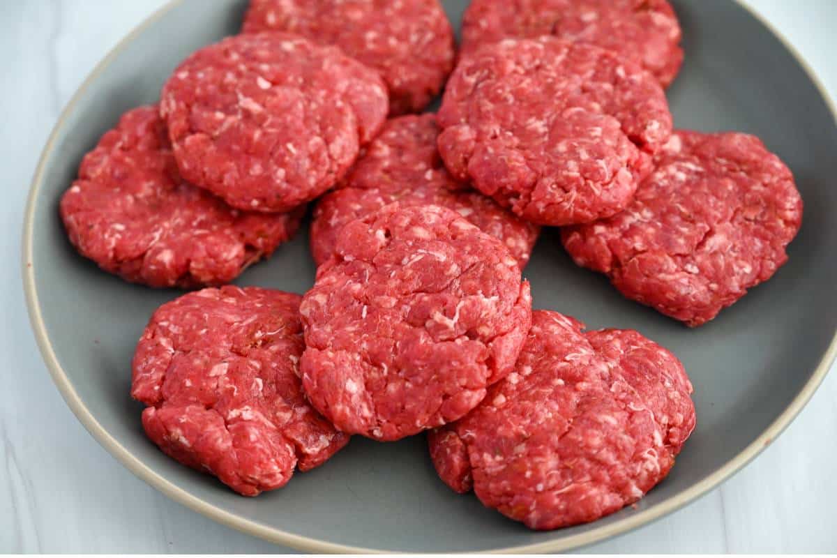 ground beef sausage made into patties on a plate