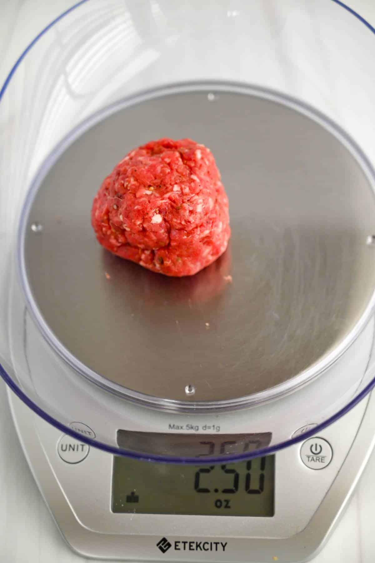 a ball of ground beef on a food scale