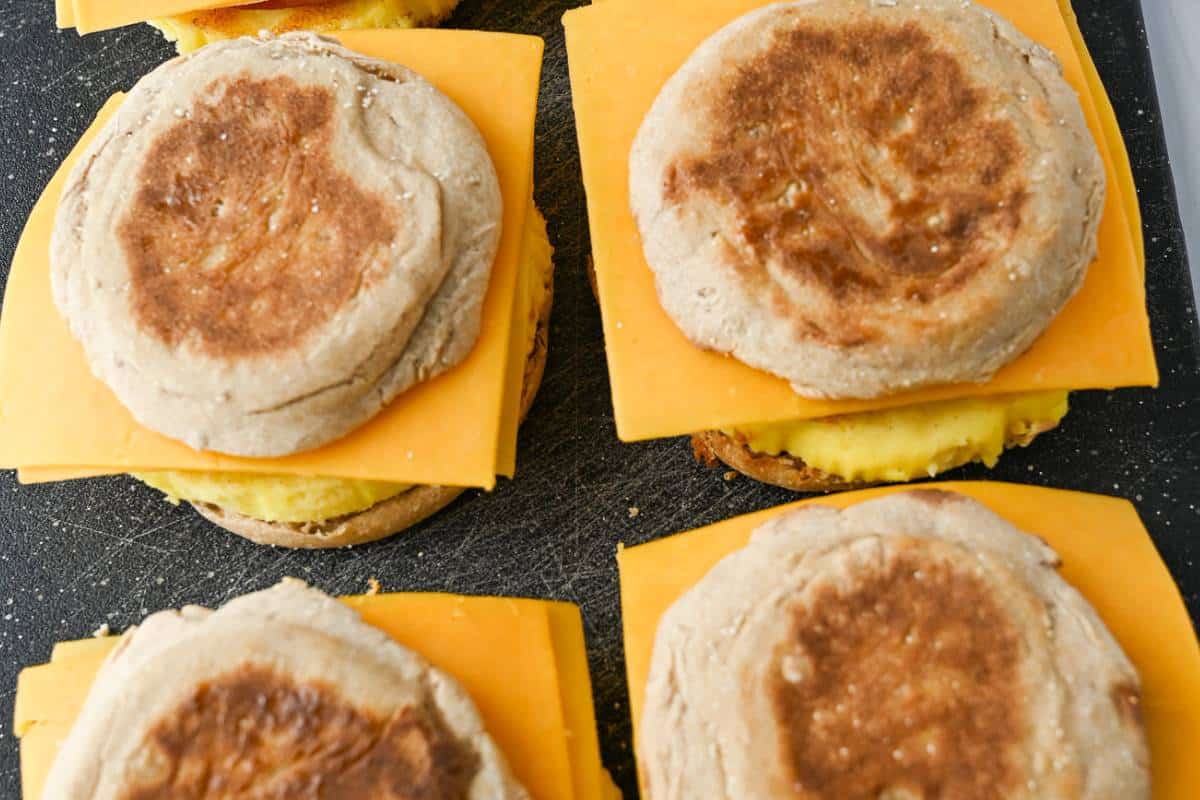 Assembled homemade egg mcmuffins on a cutting board