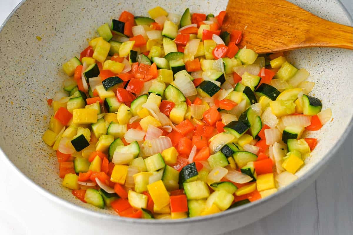 diced vegetables sauteed in a skillet