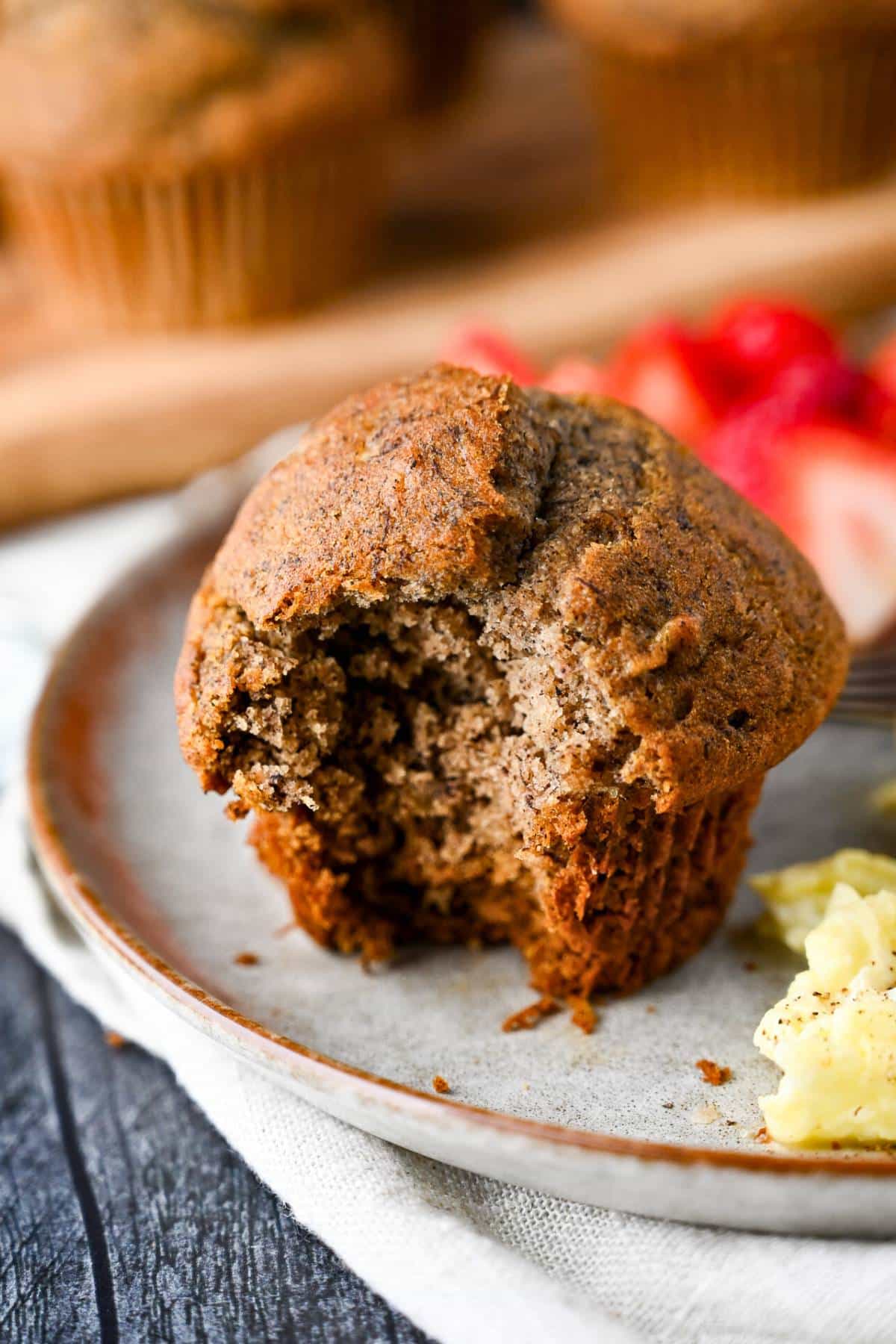 a buckwheat banana muffin with a bite taken out of it on a plate