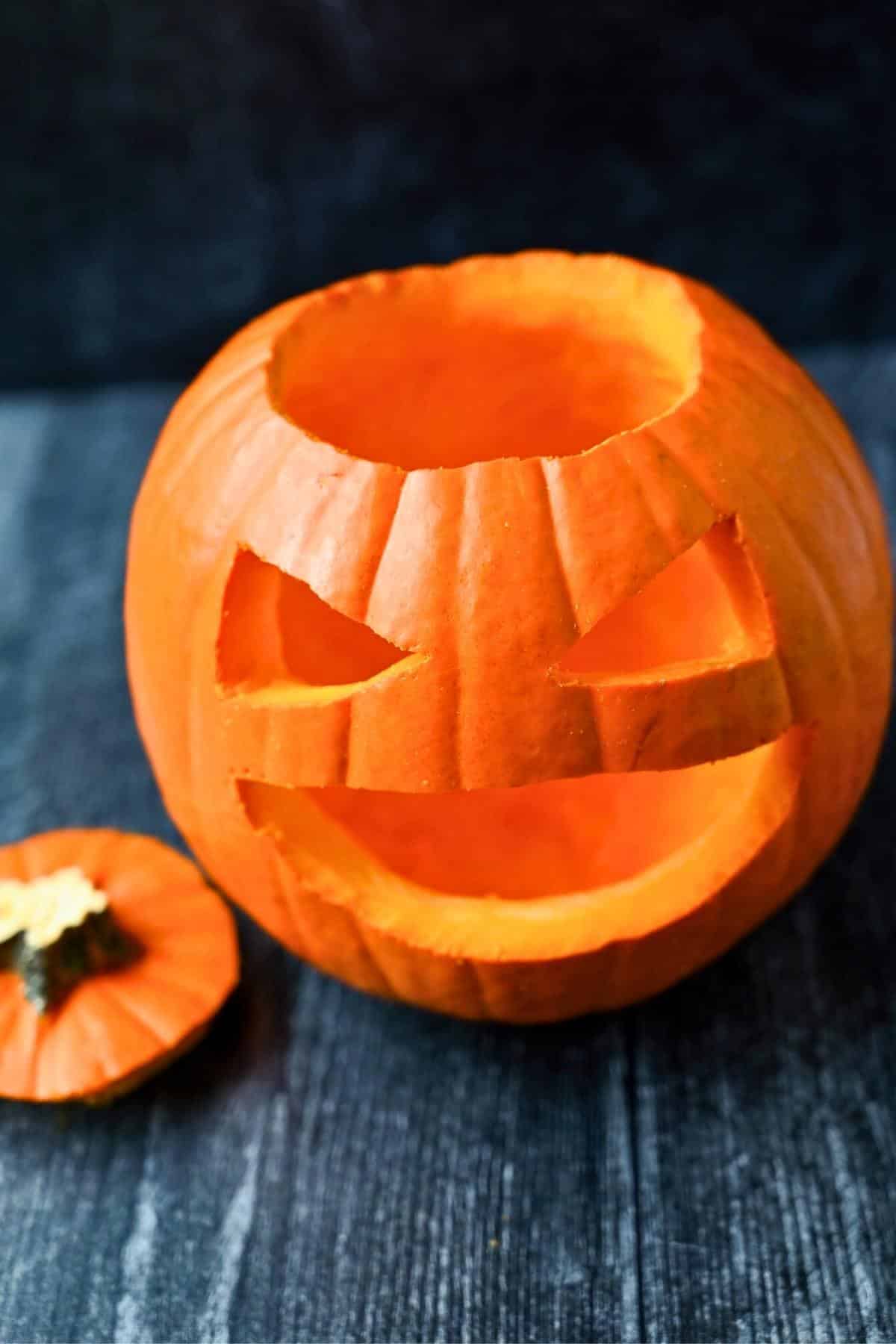 a carved pie pumpkin with the top off