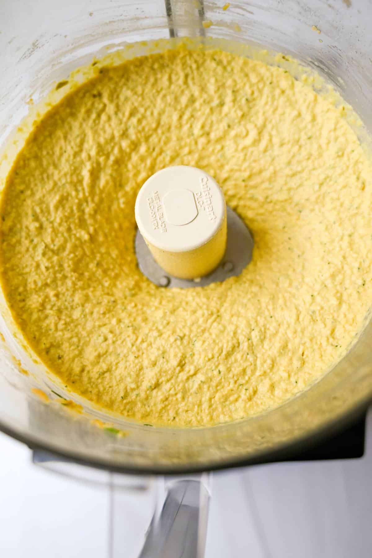 blended dill pickle hummus in a food processor bowl