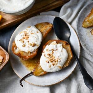 two air fried pears on a plate topped with whipped cottage cheese and cinnamon