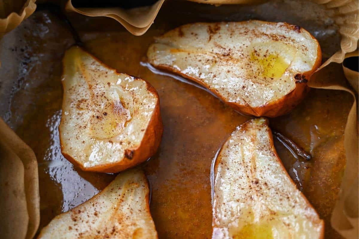 cooked roasted pears in a parchment-lined air fryer basket