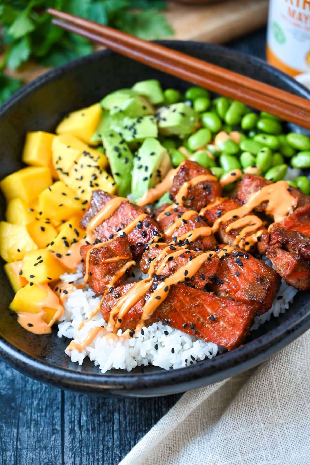 Flavorful marinated air-fried salmon bites paired with jasmine rice and fresh poke bowl toppings for a fast high-protein weeknight dinner! via @Ameessavorydish