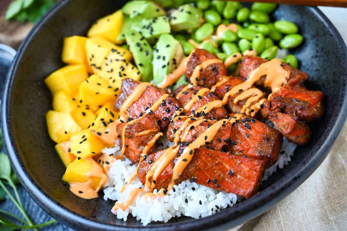 salmon poke bowl with Sriracha mayo on top