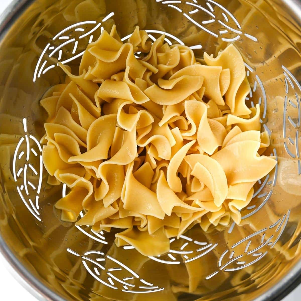 cooked noodles in a colander