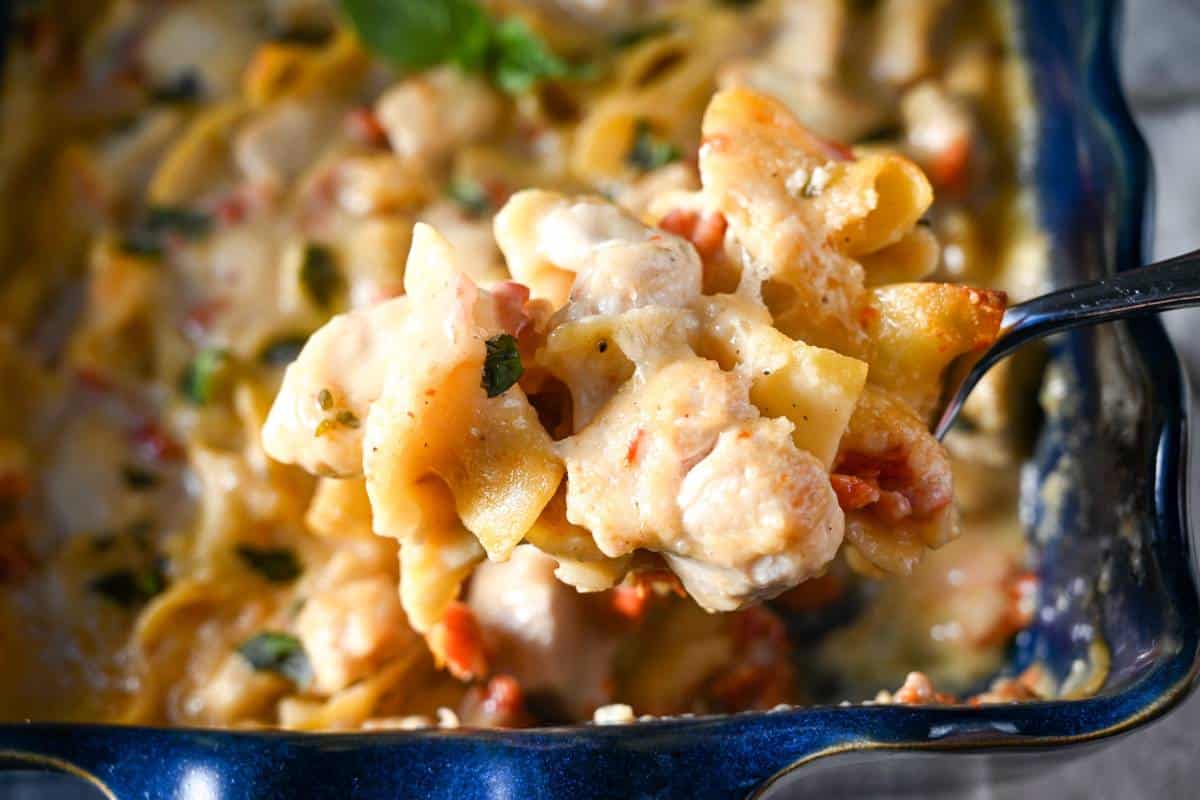 a spoonful of chicken casserole with a sundried tomato cream sauce