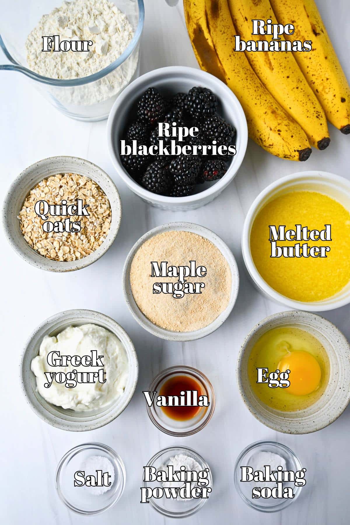 ingredients for bakery style banana muffins with blackberries measured out on a counter