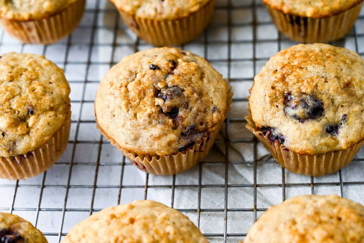 banana muffins with ripe blackberries baked and cooling on a rack