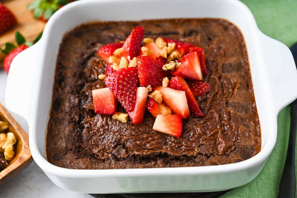 close up of a dish of brownie baked oats with strawberries 