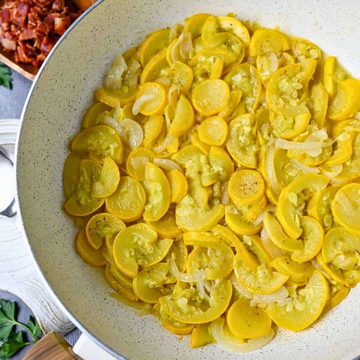 stewed squash in a white skillet