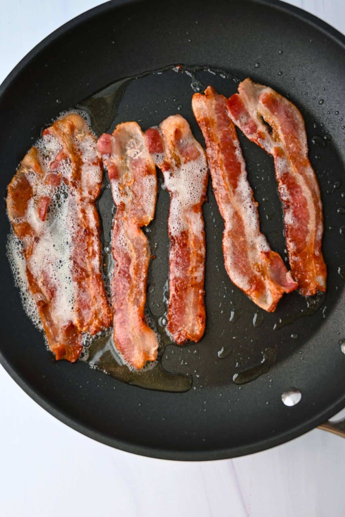 bacon cooking in a skillet