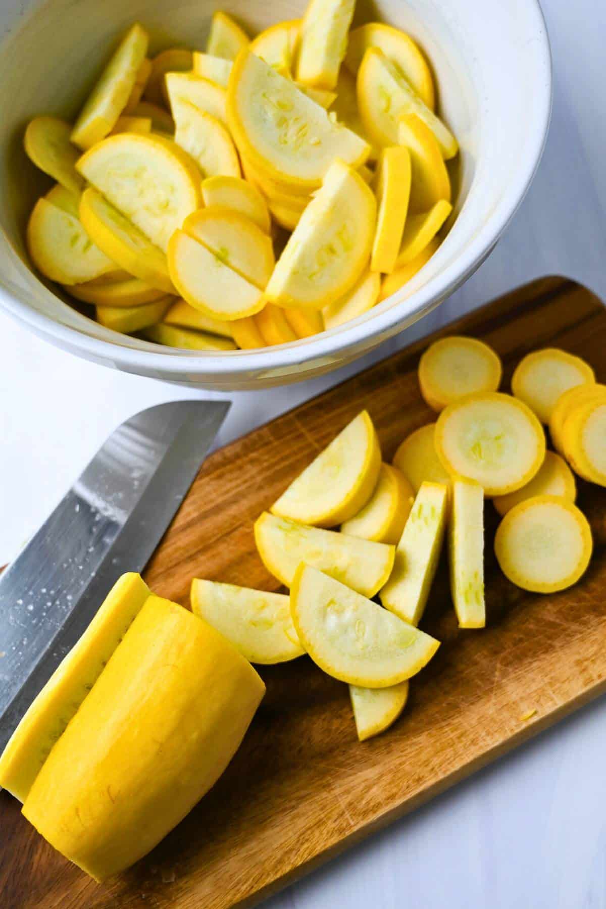 sliced squash on a cutting board and in a bowl