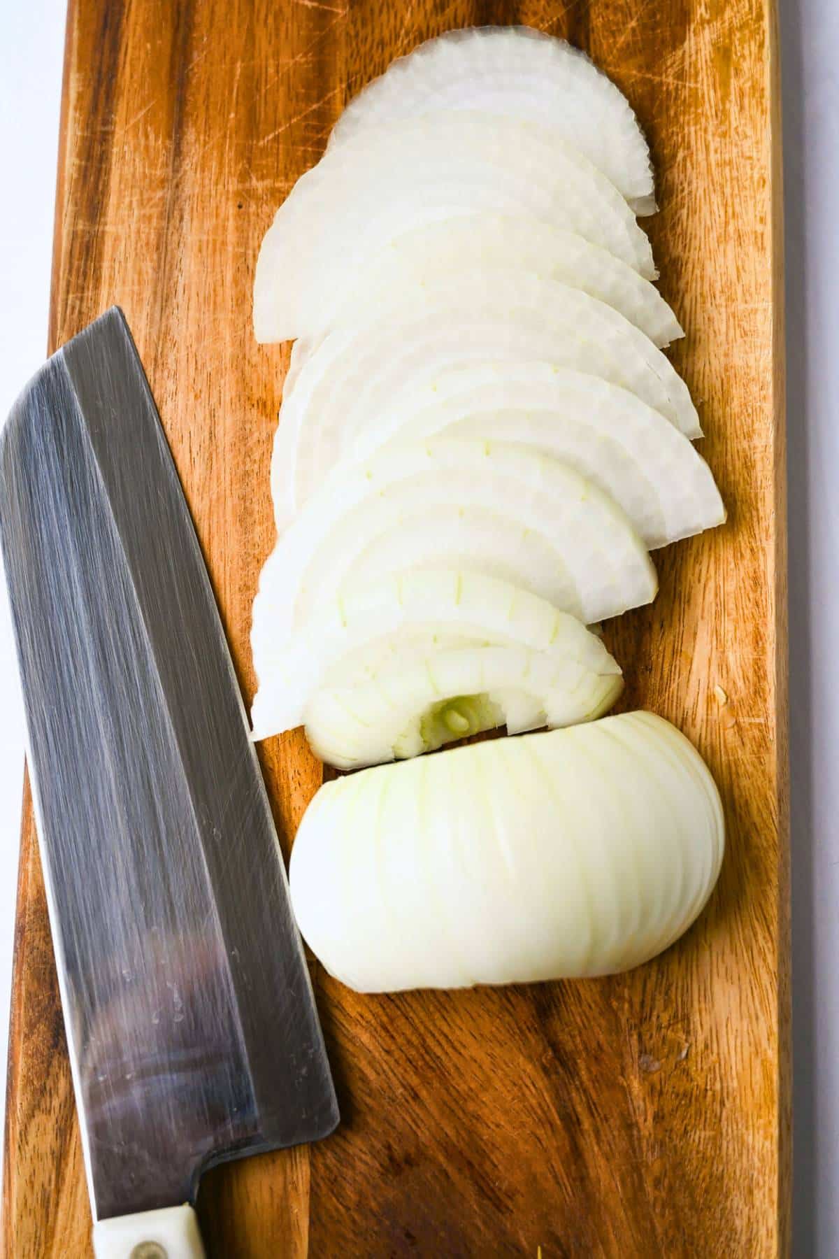 sliced onions on a cutting board