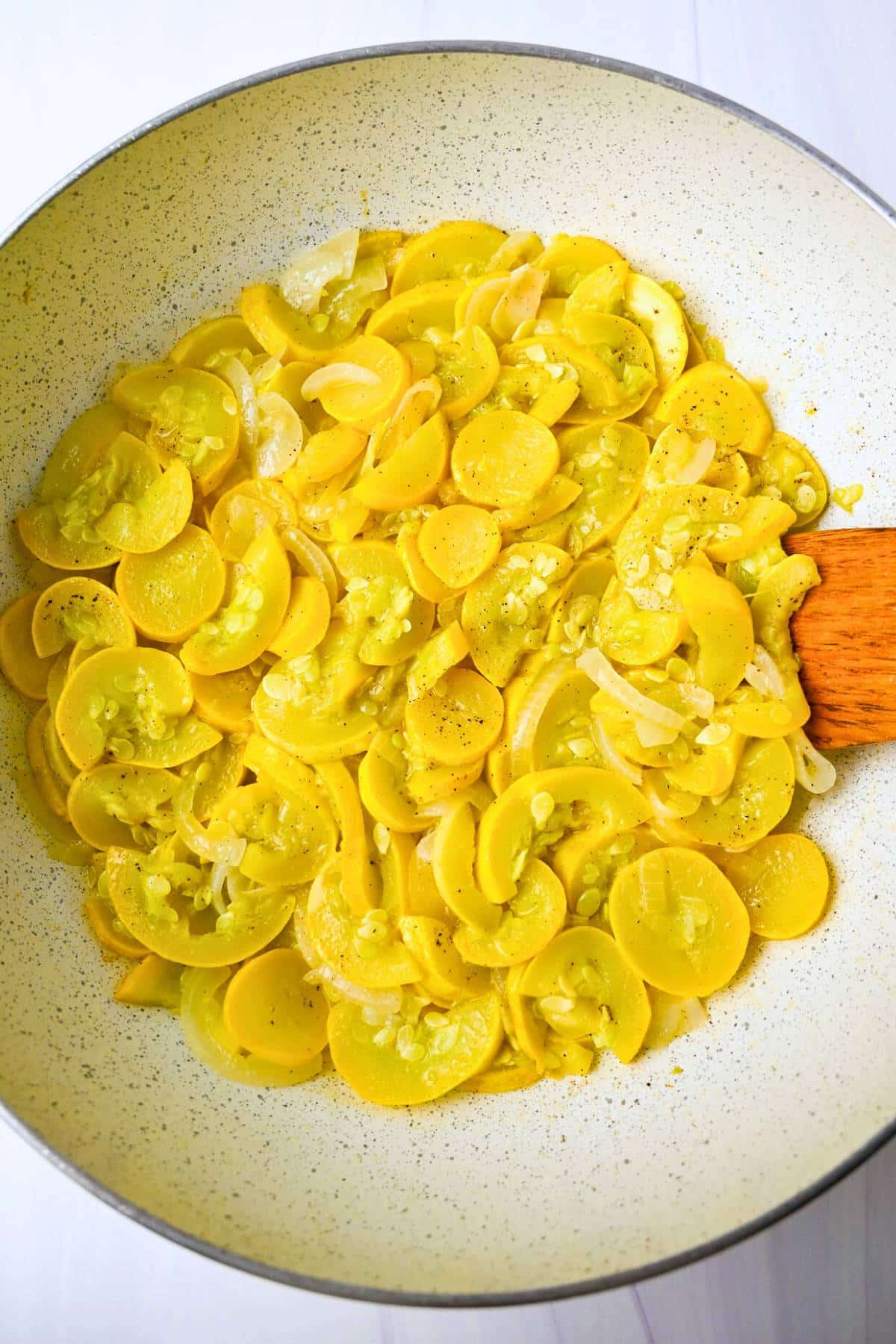 squash and onions cooking in a skillet