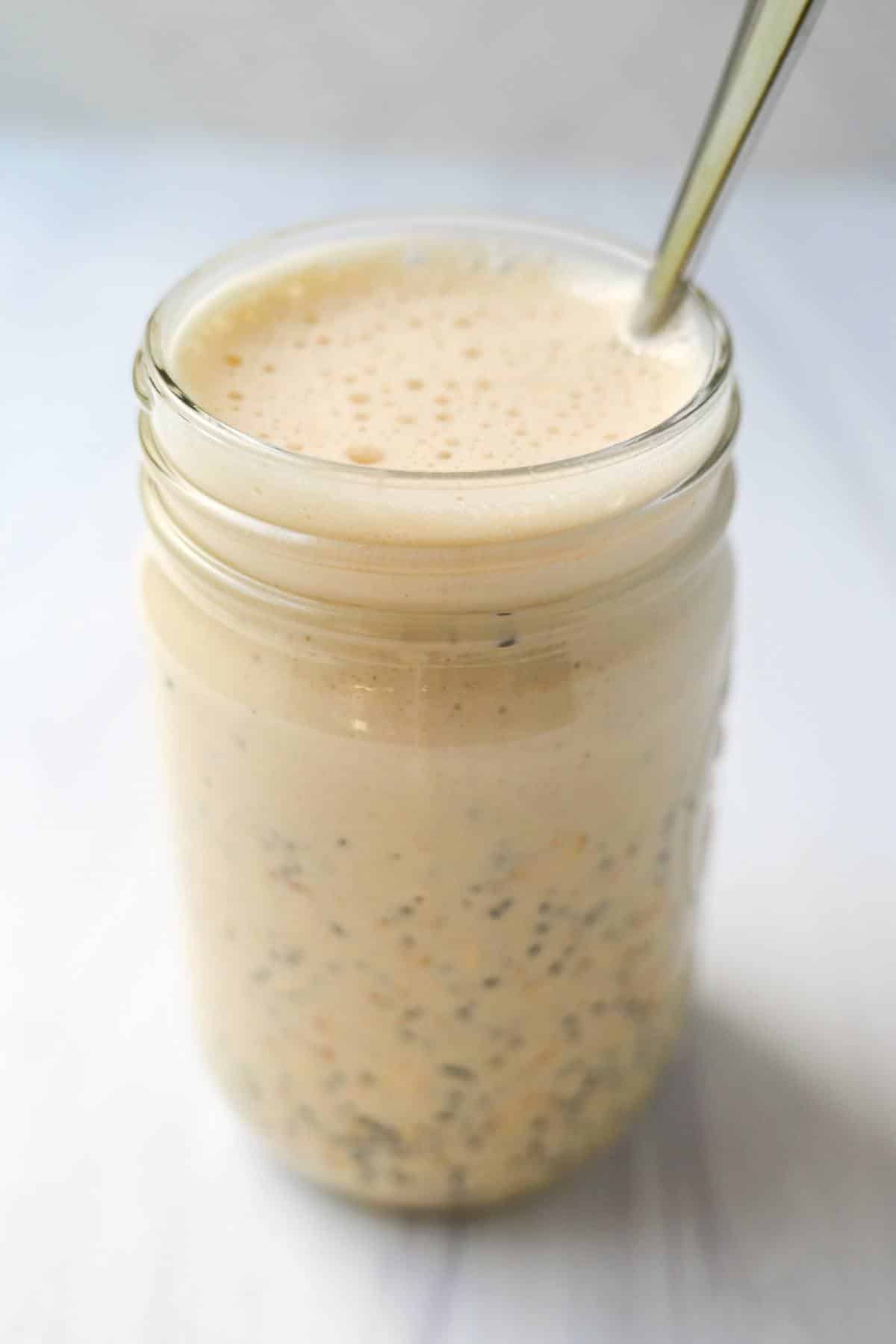 mixed ingredients in a mason jar for reeses pb oats