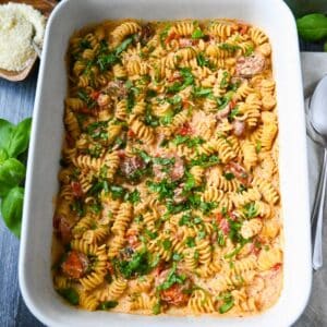 looking down at a pan of boursin tomato pasta with rotini noodles and Italian chicken sausage