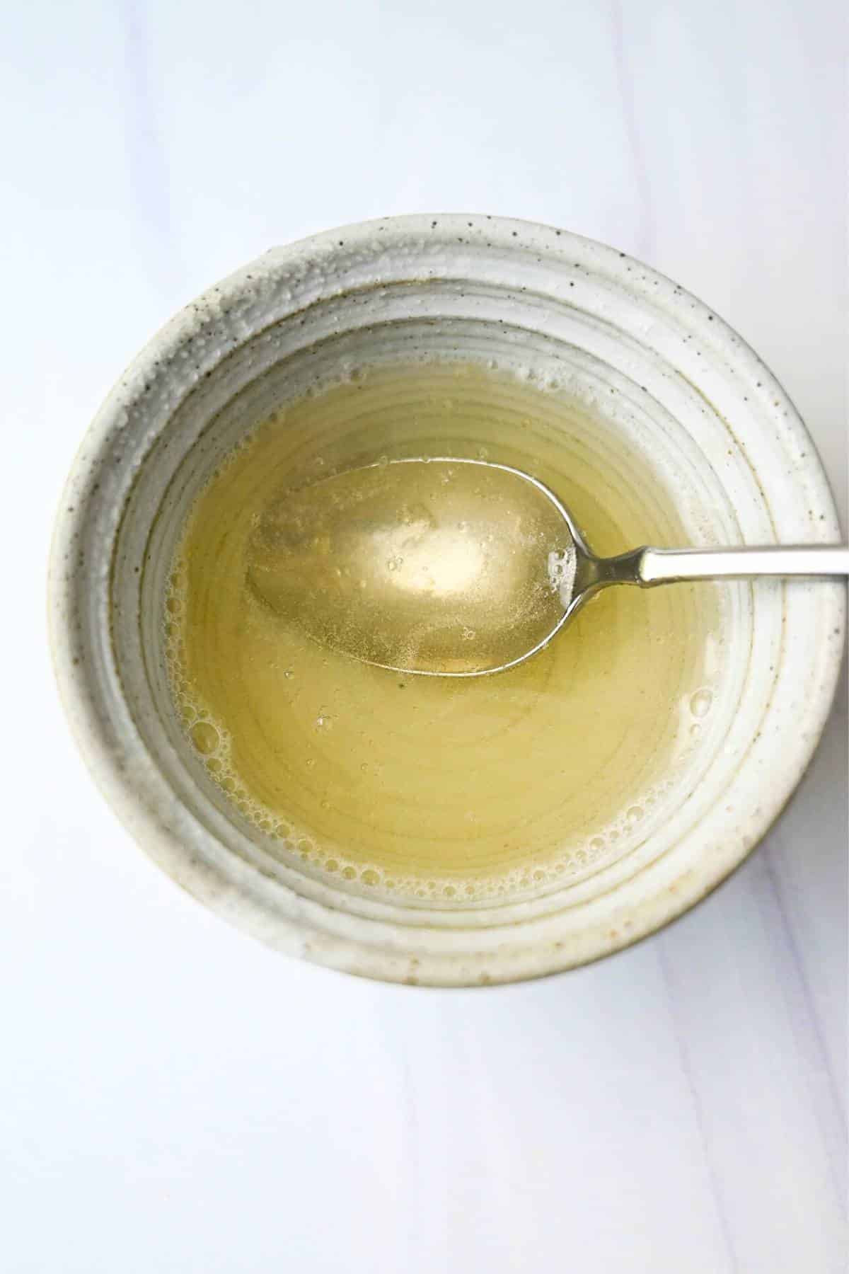 dissolved gelatin in water with a spoon