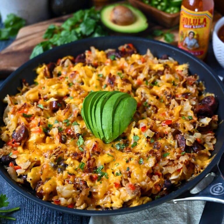 close up of a breakfast skillet with avocado sliced on top