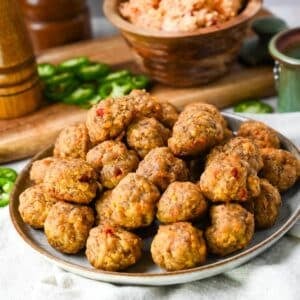 a plate of sausage balls made with spicy pimento cheese